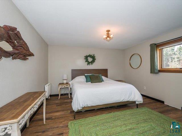 5508 Nordling Road Duluth, MN 55804 - Photo 21 of 58 Bedroom featuring dark wood-type flooring and radiator heating unit