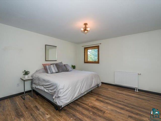 5508 Nordling Road Duluth, MN 55804 - Photo 23 of 58 Bedroom with radiator and dark wood-style floors