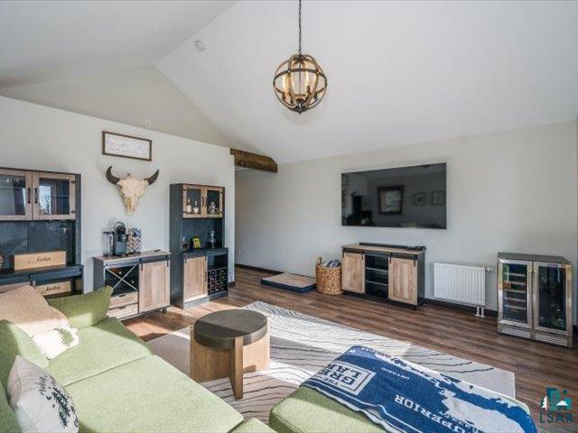 5508 Nordling Road Duluth, MN 55804 - Photo 29 of 58 Bonus space with radiator, wood finished floors, a chandelier, and high vaulted ceiling