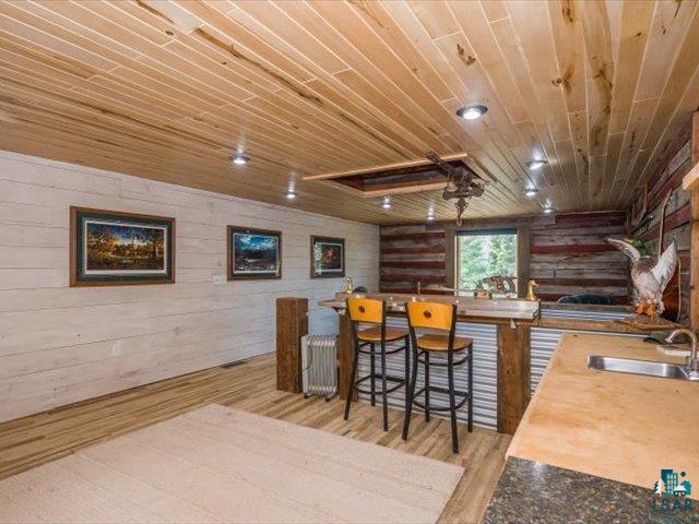 5508 Nordling Road Duluth, MN 55804 - Photo 37 of 58 Upper level of Barn, featuring wooden ceiling, wood walls, and light wood-style floors