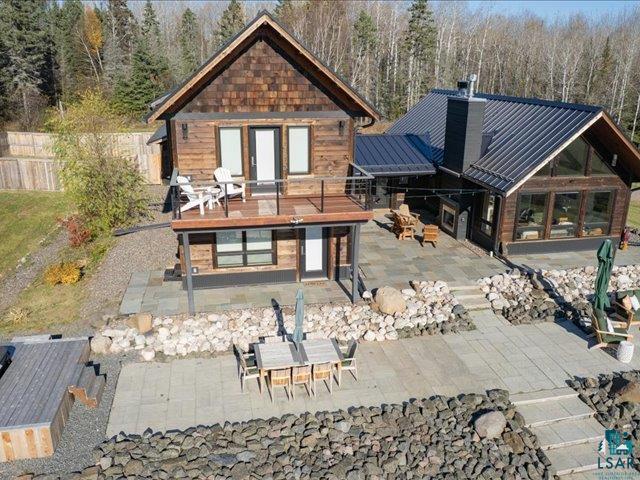 5508 Nordling Road Duluth, MN 55804 - Photo 43 of 58 Front of property featuring a patio, outdoor dining area, a metal roof, a standing seam roof, and a chimney