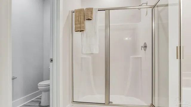a bathroom with a shower and a toilet