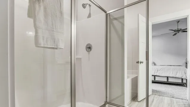 a bathroom with a shower and a glass door