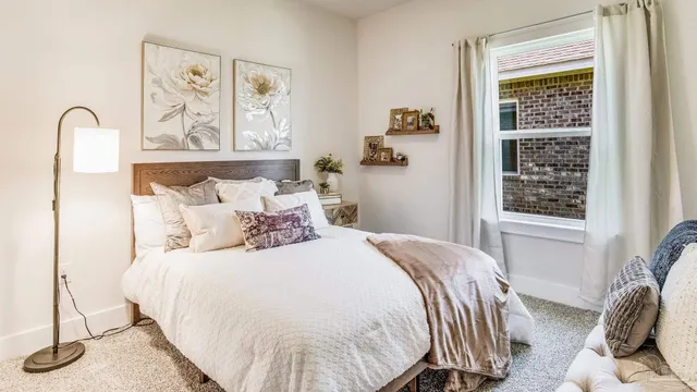 a bedroom with bed and a window