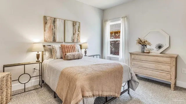 a bedroom with a bed and window