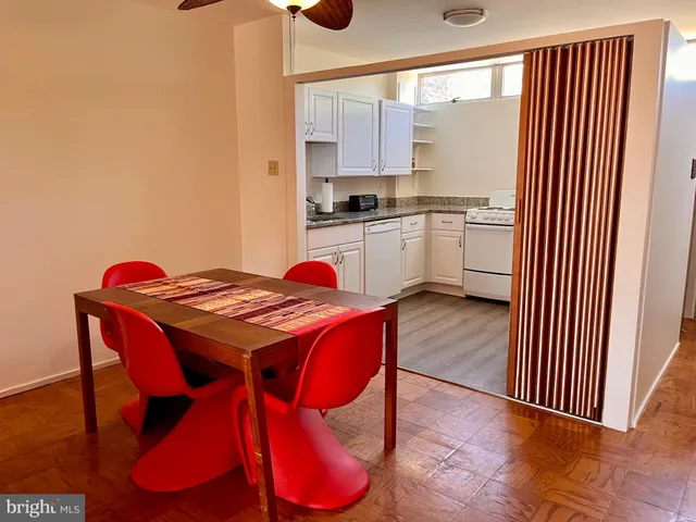 a kitchen with a table chairs sink and cabinets