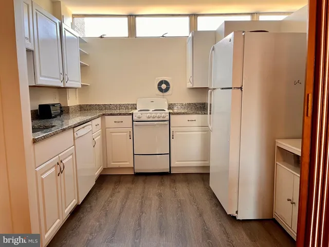 a kitchen with appliances a sink and a refrigerator