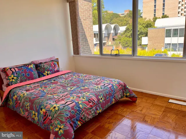 a bed sitting in a bedroom next to a window