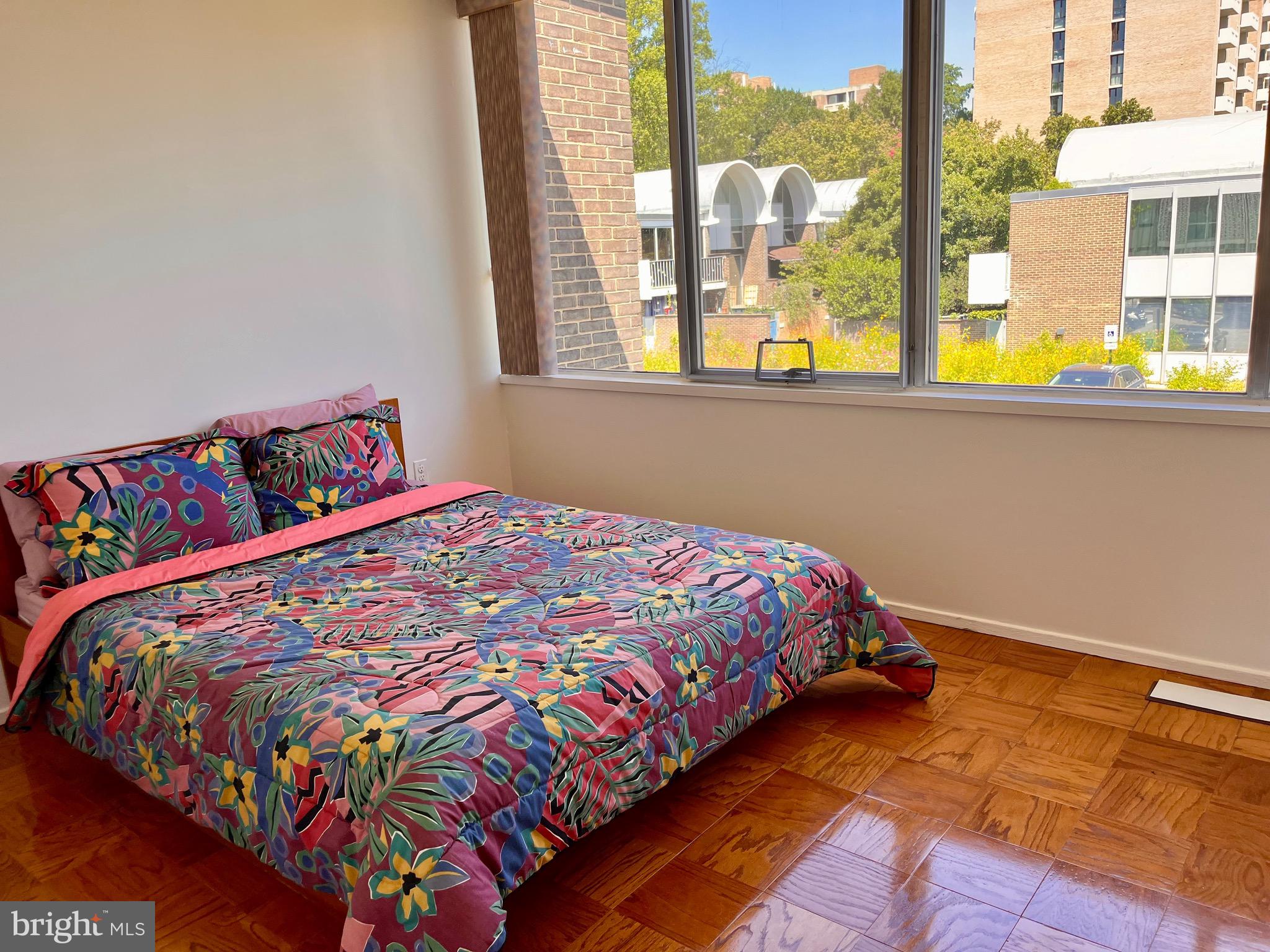 1340 4th Street Southwest, Unit T1340 Washington, DC 20024 - Photo 9 of 40 a bed sitting in a bedroom next to a window