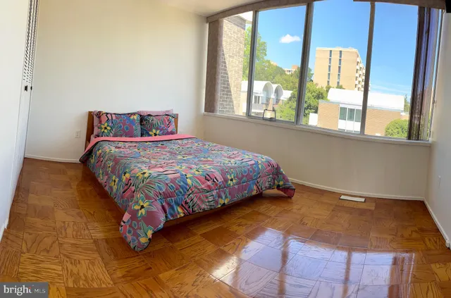 a bedroom with a bed and window