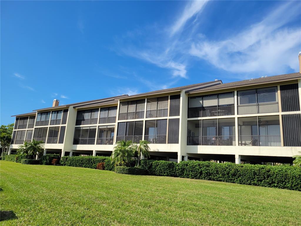 3905 Mariners Walk, Unit 813 Cortez, FL 34215 - Photo 1 of 27 a front view of a house with a garden