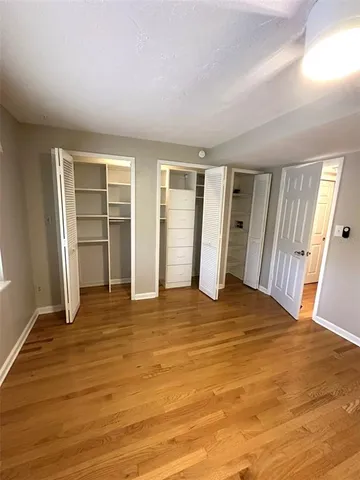 a bathroom with a double vanity sink toilet mirror and shower