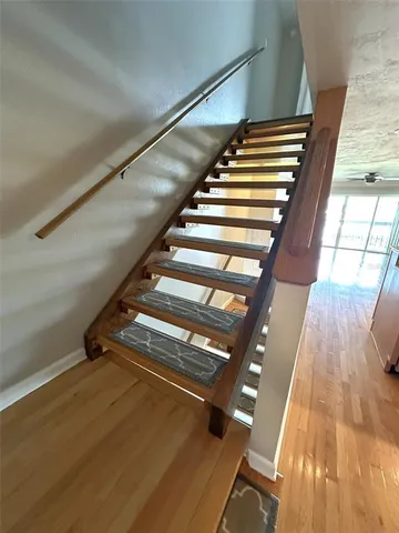 a view of a room with wooden floor and stairs