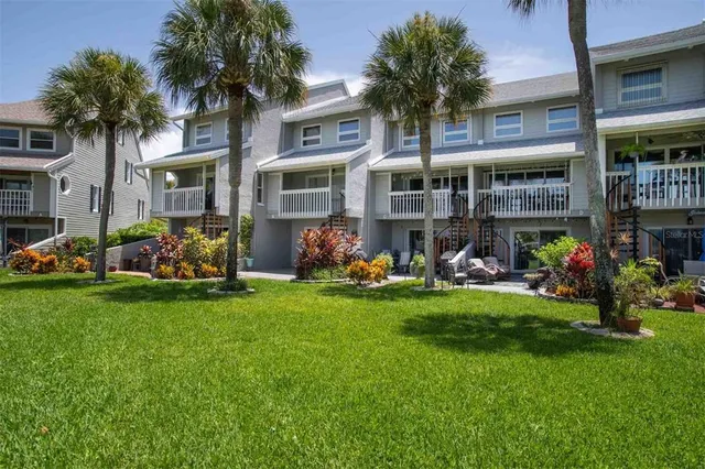 a front view of a building and car parked
