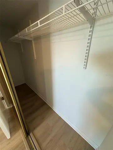 a bathroom with a granite countertop sink a toilet and a mirror