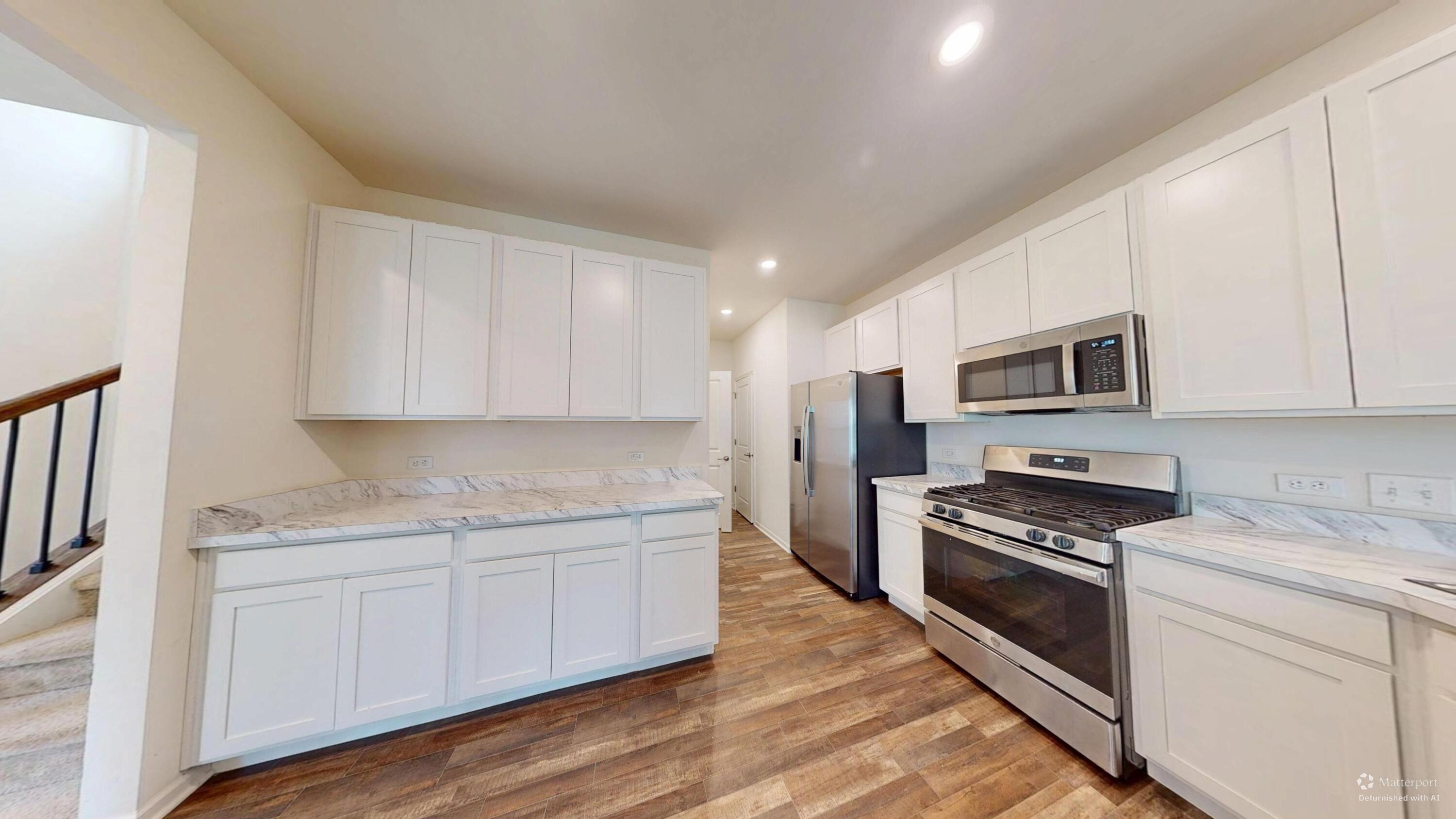 1832 East 110th Lane Crown Point, IN 46307 - Photo 11 of 20 a kitchen with stainless steel appliances granite countertop a stove a sink and a refrigerator