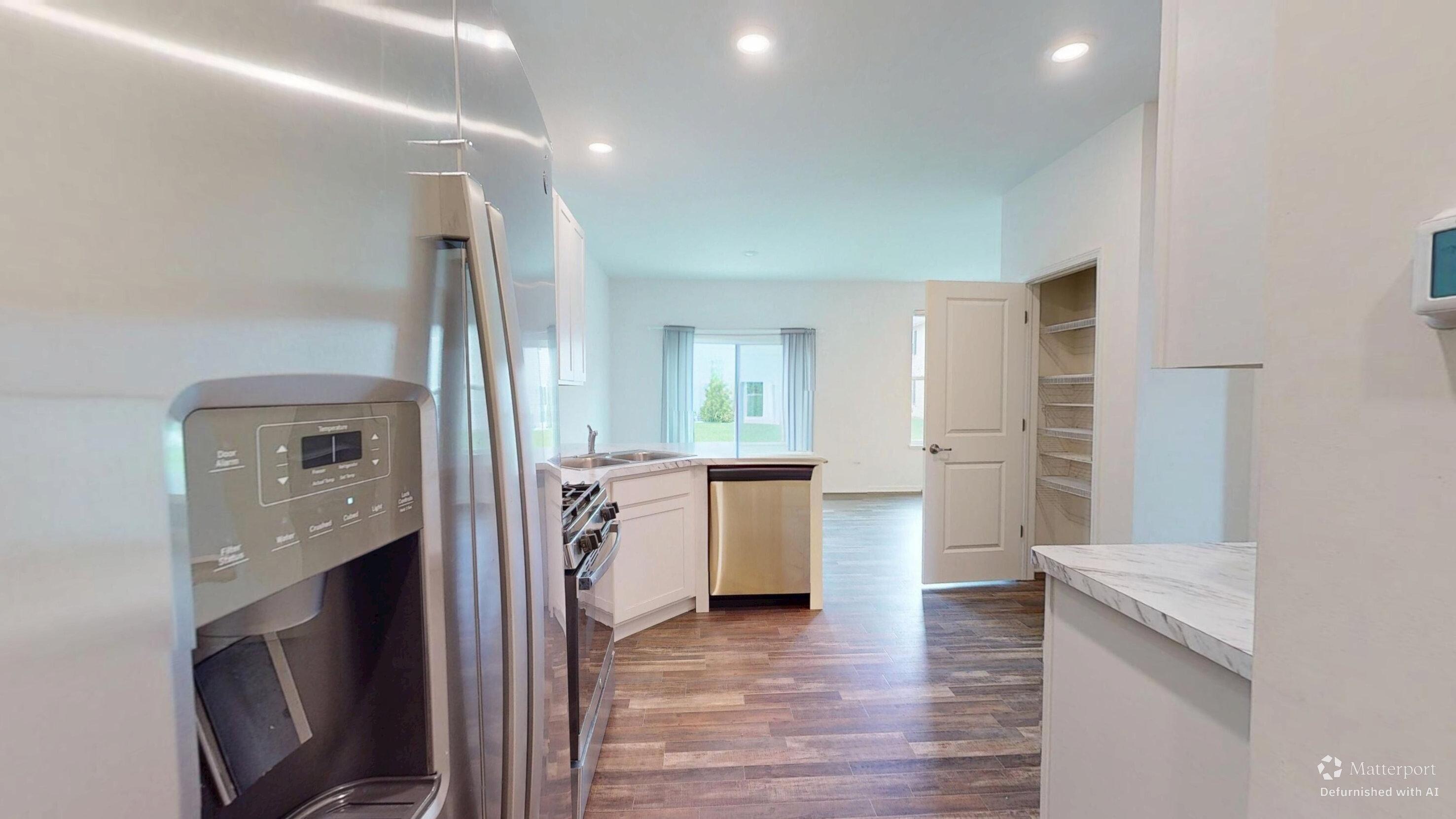 1832 East 110th Lane Crown Point, IN 46307 - Photo 12 of 20 a view of a kitchen with a sink and a refrigerator