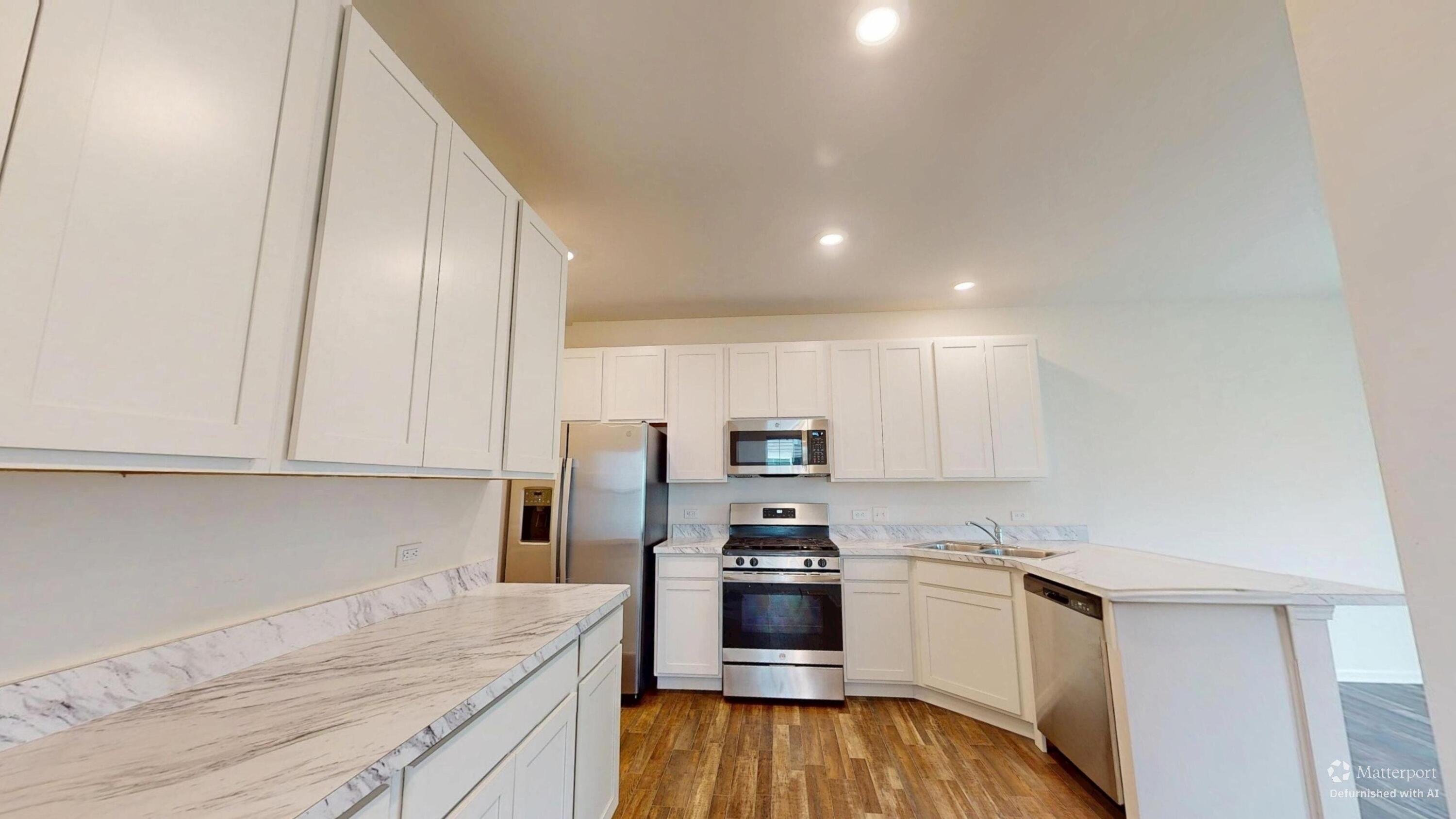 1832 East 110th Lane Crown Point, IN 46307 - Photo 14 of 20 a kitchen with stainless steel appliances a refrigerator sink and stove