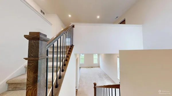 a view of a hallway with wooden floor and entryway