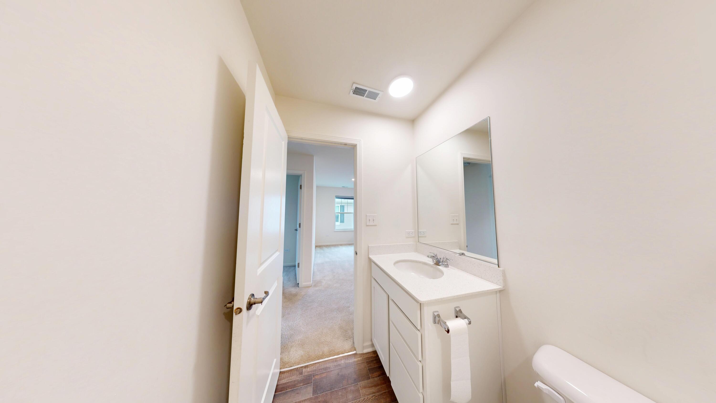 1832 East 110th Lane Crown Point, IN 46307 - Photo 17 of 20 a bathroom with a sink a toilet and a mirror