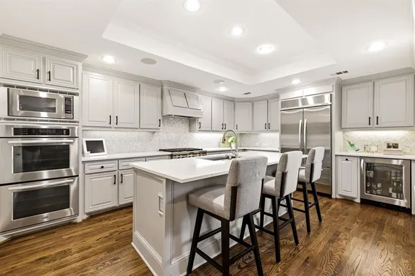 a kitchen with a stove a sink and a microwave