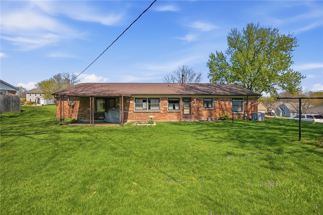 6225 Possum Run Road Bellbrook, OH 45305 - Photo 29 of 33 This residence features a spacious yard and classic brick construction under a clear sky.