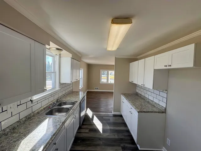 a kitchen with granite countertop a stove and a sink
