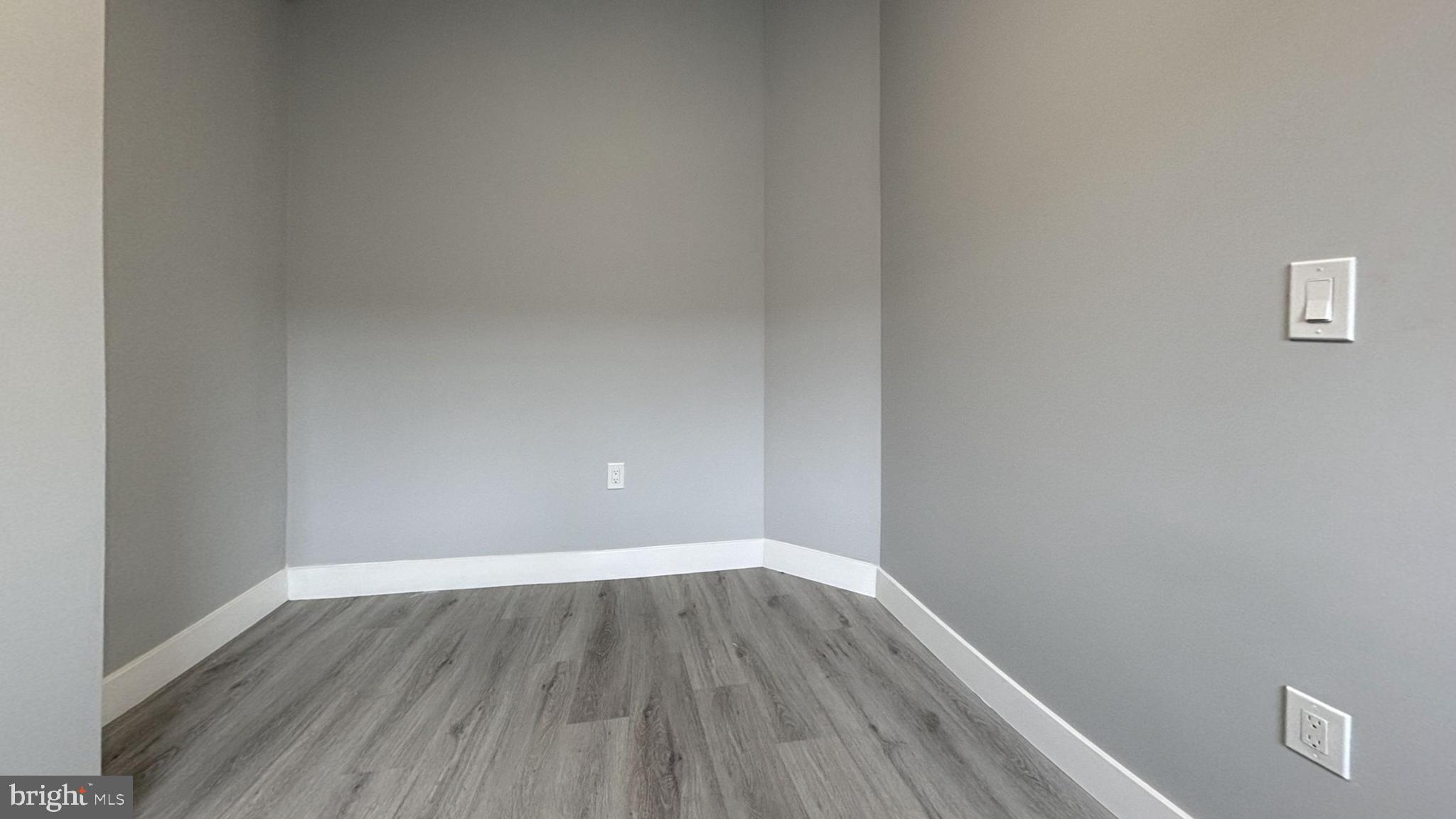 1329 South 29th Street Philadelphia, PA 19146 - Photo 2 of 4 a view of a small space with wooden floor and a window