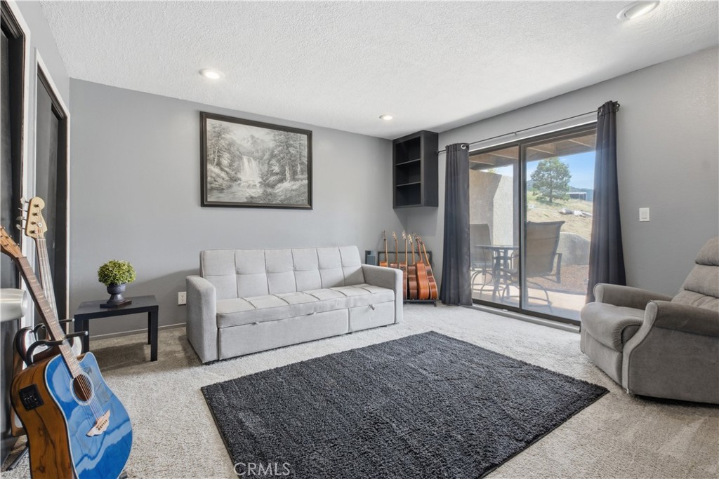 26201 Cumberland Road Tehachapi, CA 93561 - Photo 23 of 36 a living room with furniture and a rug