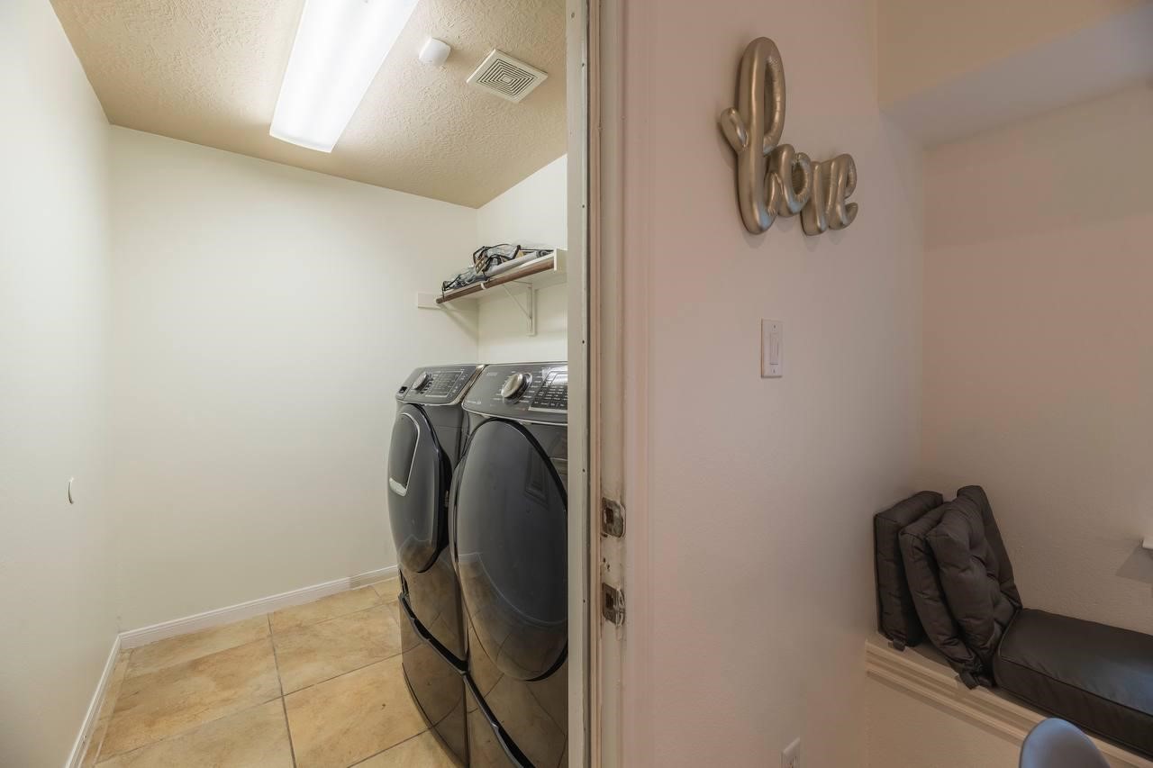 6 Avenswood Place Spring, TX 77382 - Photo 12 of 22 a view of a storage and utility room with a washer dryer