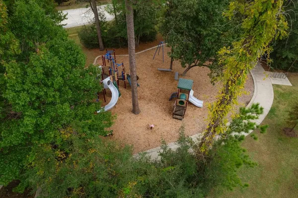 an aerial view of residential house with outdoor space and trees all around
