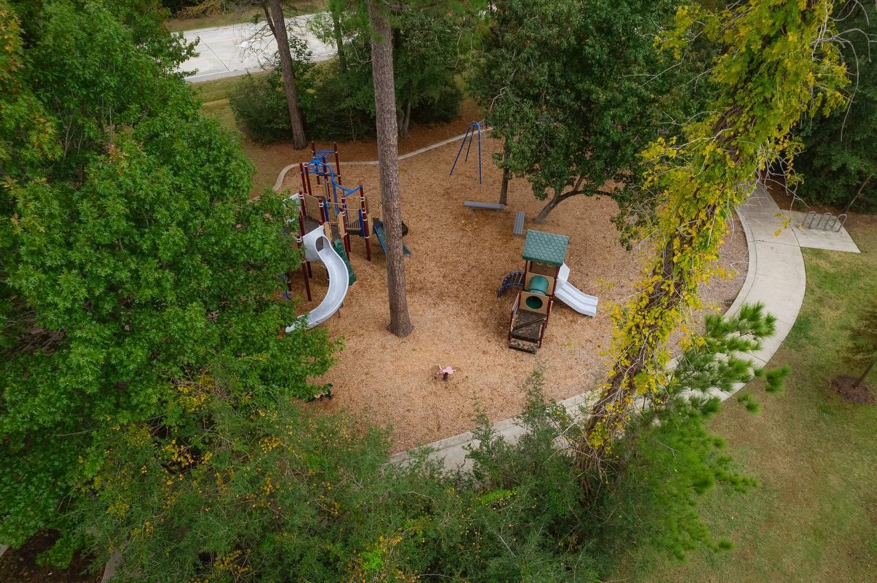 6 Avenswood Place Spring, TX 77382 - Photo 22 of 22 an aerial view of residential house with outdoor space and trees all around
