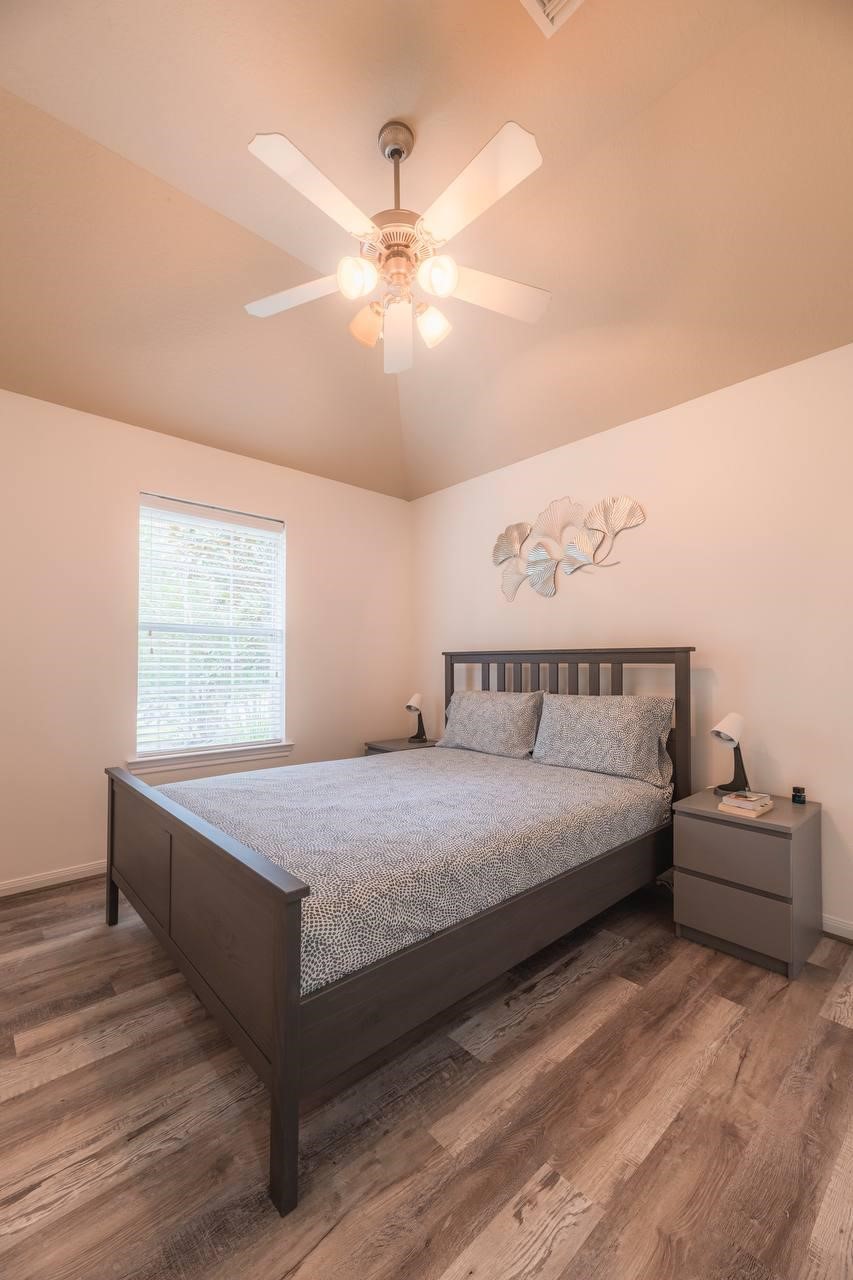 6 Avenswood Place Spring, TX 77382 - Photo 6 of 22 a spacious bedroom with a bed and a chandelier