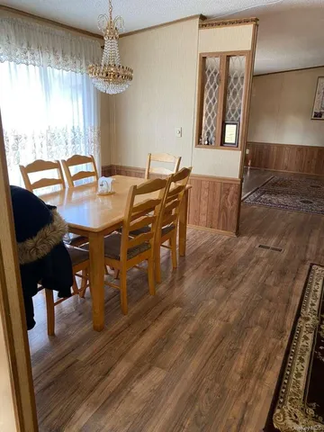 a view of a dining room with furniture and window