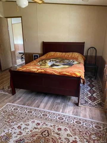 a bed sitting in a bedroom next to a window