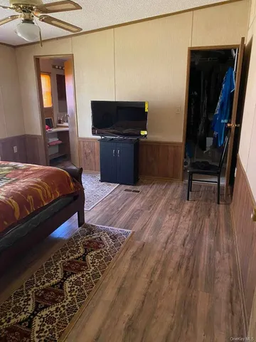 a bedroom with a bed and a desk