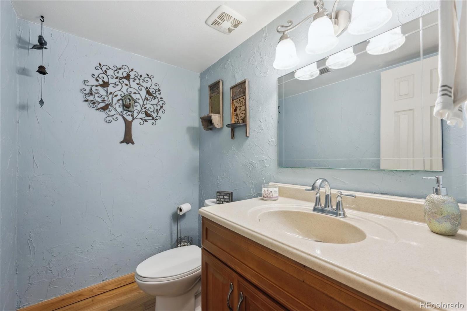 8403 Chase Drive Arvada, CO 80003 - Photo 18 of 39 a bathroom with a sink vanity granite and toilet