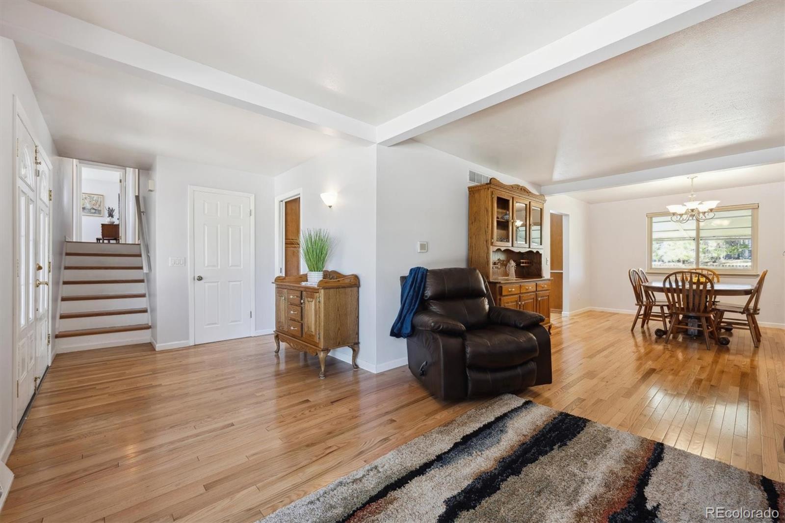 8403 Chase Drive Arvada, CO 80003 - Photo 20 of 39 a living room with furniture and wooden floor