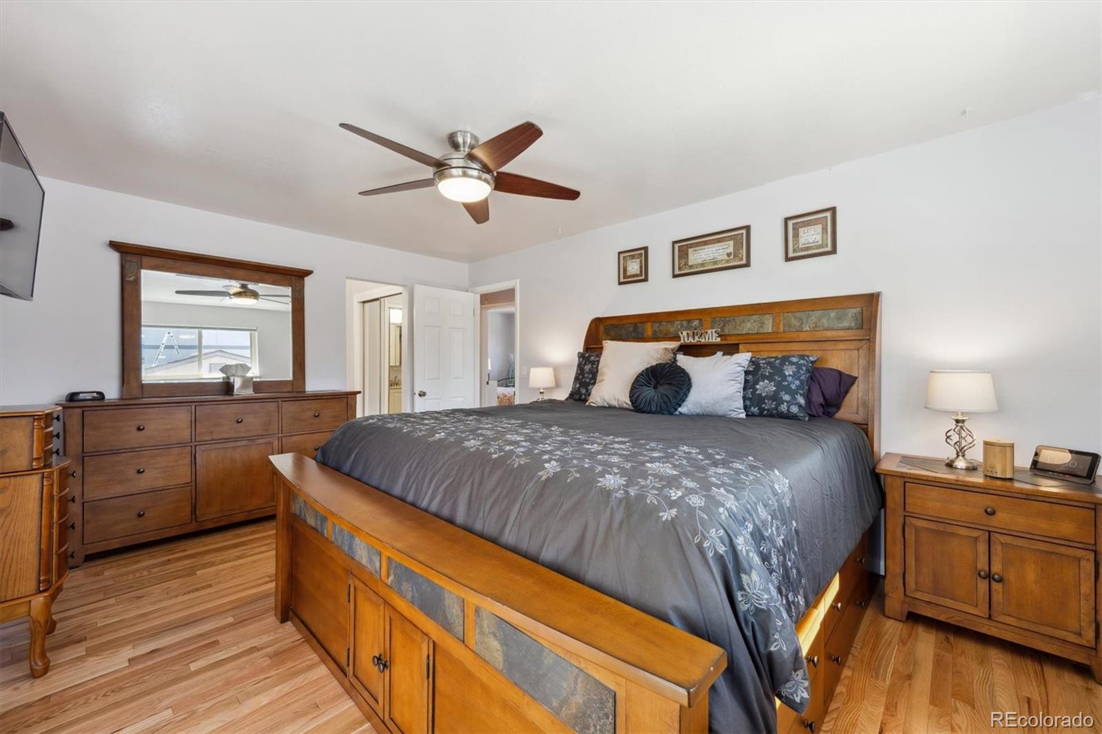 8403 Chase Drive Arvada, CO 80003 - Photo 21 of 39 a bedroom with a bed and wooden floors