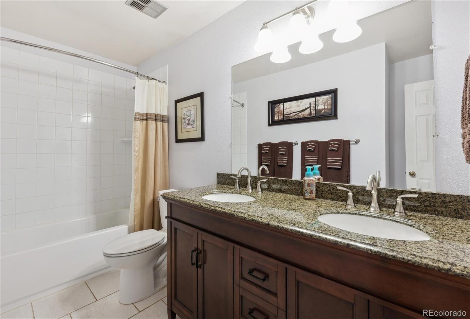 8403 Chase Drive Arvada, CO 80003 - Photo 28 of 39 a bathroom with a granite countertop sink mirror vanity and toilet