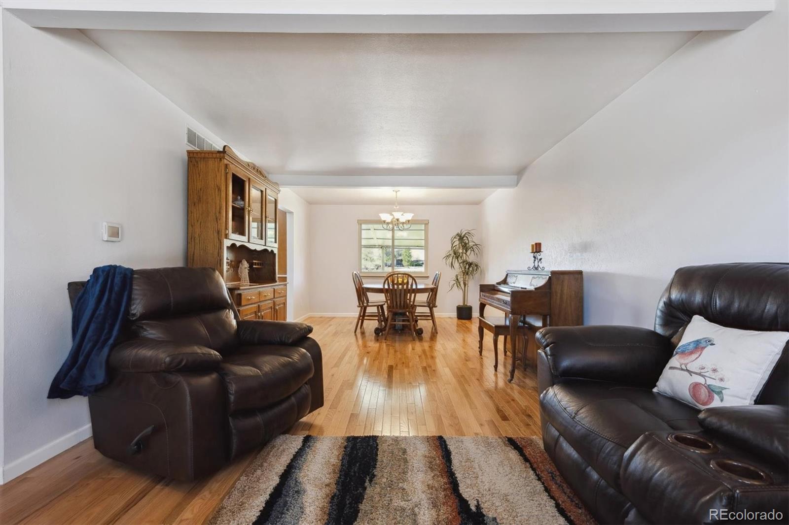 8403 Chase Drive Arvada, CO 80003 - Photo 4 of 39 a living room with furniture and wooden floor