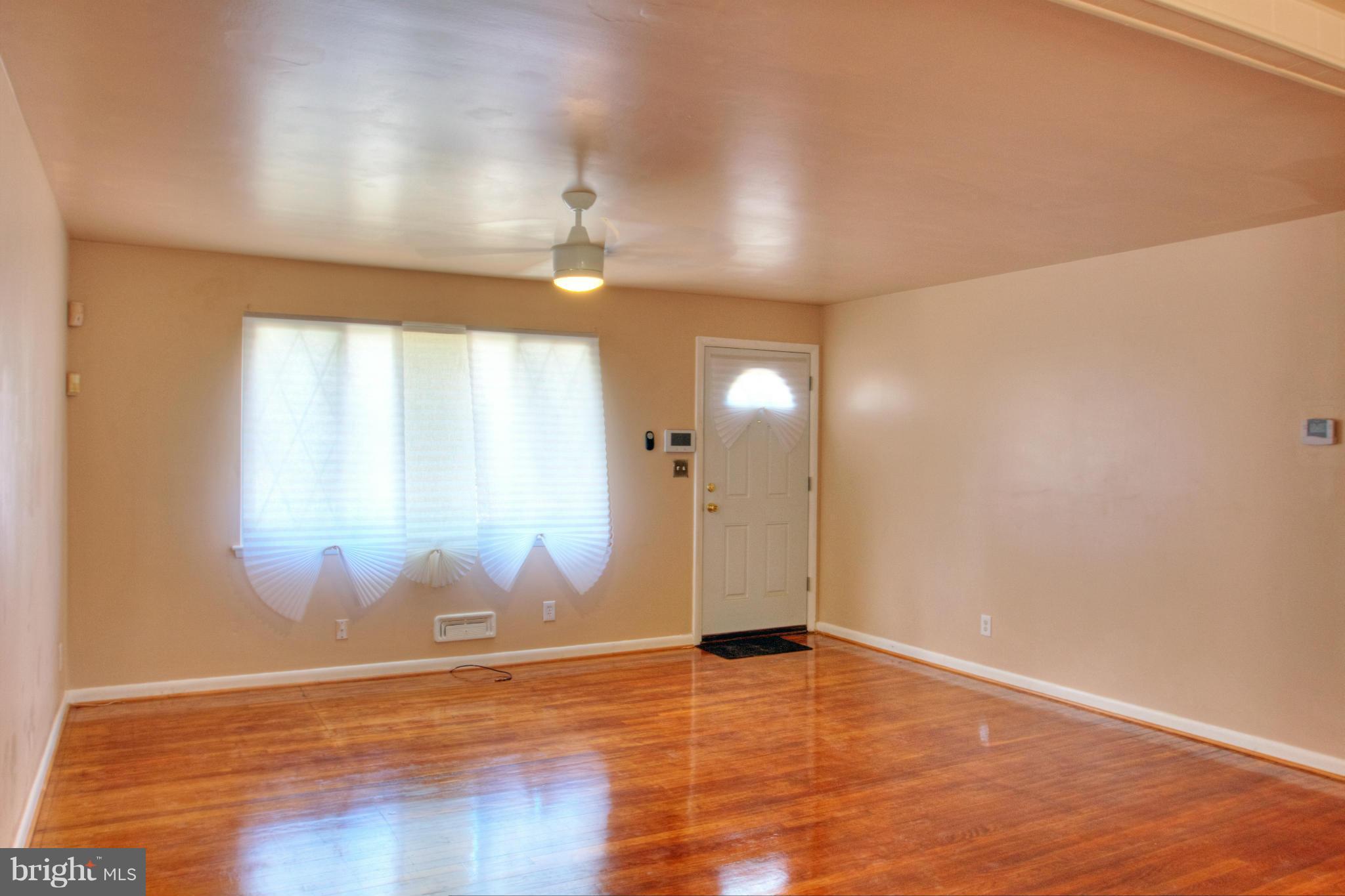 3705 Collier Road Randallstown, MD 21133 - Photo 3 of 30 an empty room with wooden floor and windows