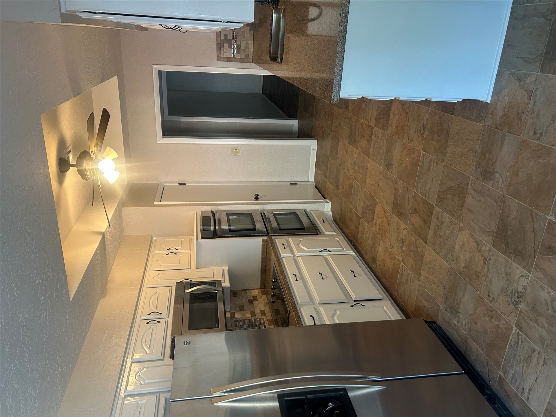 2913 Springdale Lane Duncan, OK 73533 - Photo 25 of 32 Kitchen featuring stainless steel appliances, white cabinetry, a dual wall oven, stone countertops, and tile flooring