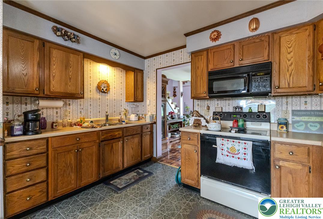 40 Locke Heights Road Bangor, PA 18013 - Photo 16 of 28 A well-lit kitchen with natural wood cabinetry offers ample storage and preparation space.