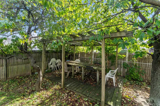 a front view of a house with a yard and potted plants