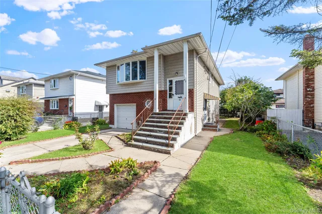 a view of a backyard with sitting area and small garden