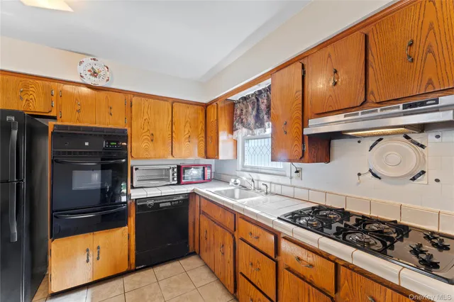 a kitchen with stainless steel appliances granite countertop a stove sink and cabinets