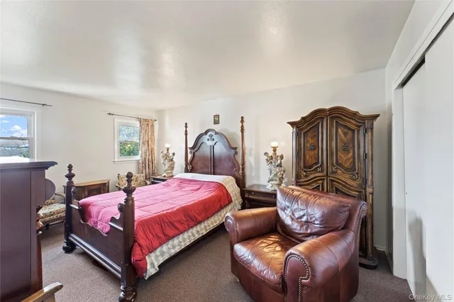 a bedroom with a bed and window