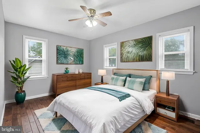 a bedroom with a large bed and a chandelier