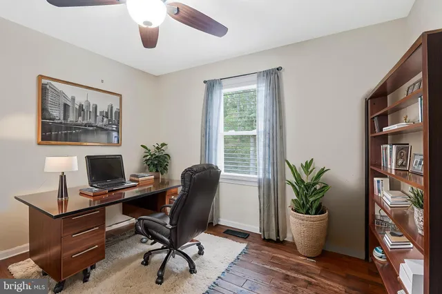 a view of a workspace with furniture and a potted plant
